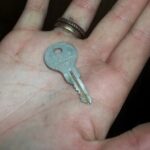 gray key in person's palm