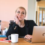 woman in black long sleeve shirt using macbook