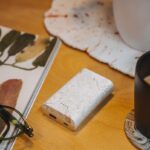 a wooden table topped with a notebook and a cup of coffee