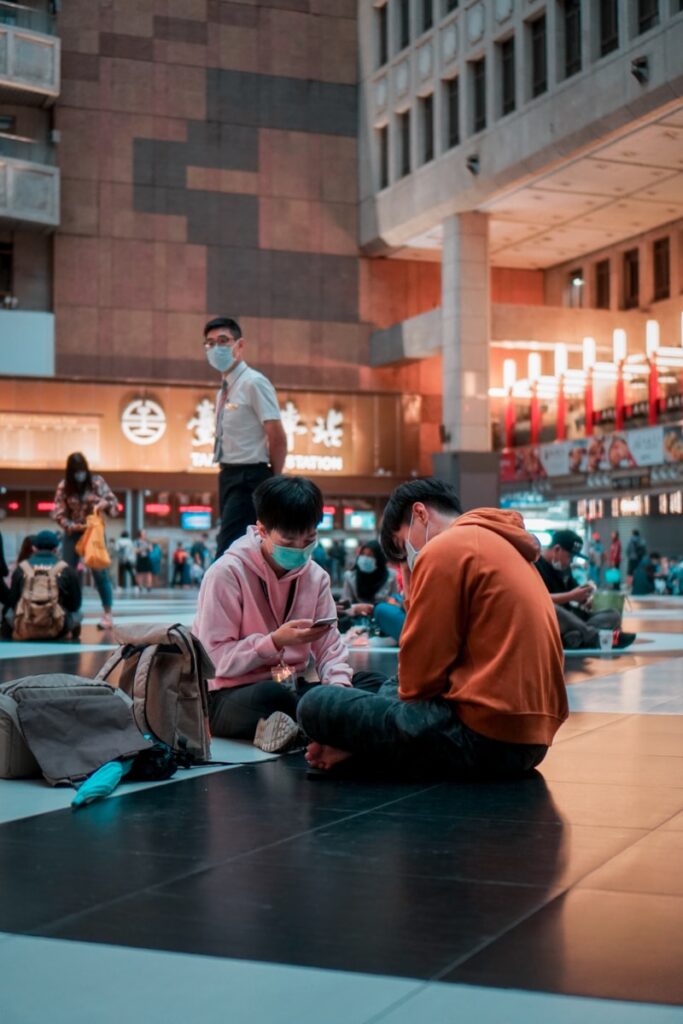 man in red long sleeve shirt sitting on floor